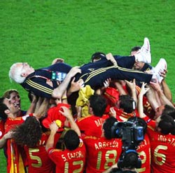 Spain coach Luis Aragones is chaired by his players following the triumph