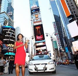 US Open champion Serena Williams poses with her trophy at the Times Square in New York