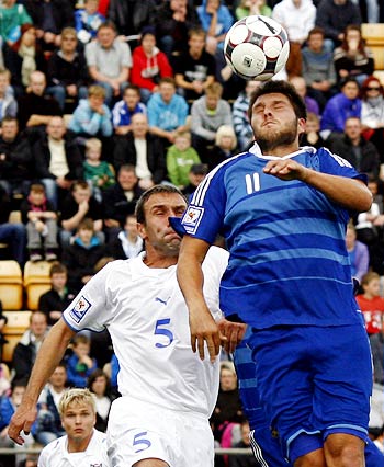 France's Andre-Pierre Gignac (right) heads the ball