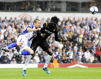 Blackburn Rovers' Gael Givet (left) challenges Manchester City striker Emmanuel Adebayor