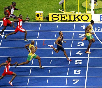 Usain Bolt finishes first ahead of Tyson Gay and Asafa Powell in the men's 100 metres final