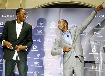 Usain Bolt (left) with Michael Johnson