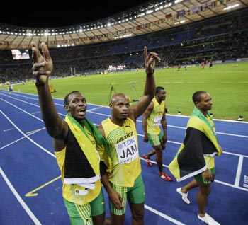 Bolt of Jamaica celebrates with team mate Powell after winning the men's 4x100 metres relay final during the world championships in Berlin