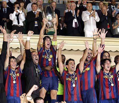 Barcelona captain Carlos Puyol lifts the European Super Cup trophy