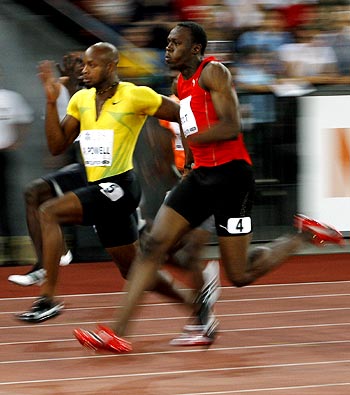 Usain Bolt (right) overtakes compatriot Asafa Powell in the men's 100 meters race