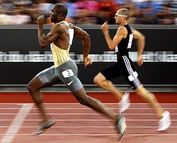 LaShawn Merritt (left) runs past Jeremy Wariner to win the men's 400 meters