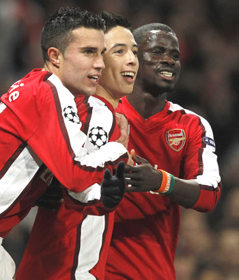 Arsenal's Samir Nasri (centre) celebrates with Robin Van Persie (left) and Emmanuel Eboue
