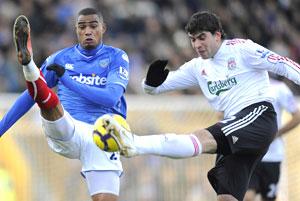 Portsmouth's Kevin-Prince Boateng (left) and Liverpool's Emiliano Insua go for the ball during their English Premier League tie at Fratton Park in Portsmouth on Saturday