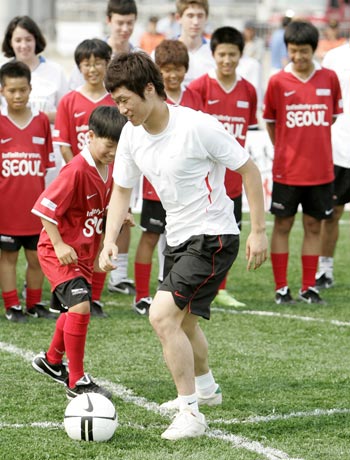 South Korea's Park Ji-sung dribbles during a soccer clinic in Seoul.