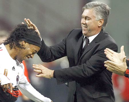 AC Milan's Ronaldinho celebrates with coach Carlo Ancelotti after scoring