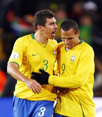 Brazil captain Lucio celebrates with his team mate Luis Fabiano after scoring the winning goal against the US