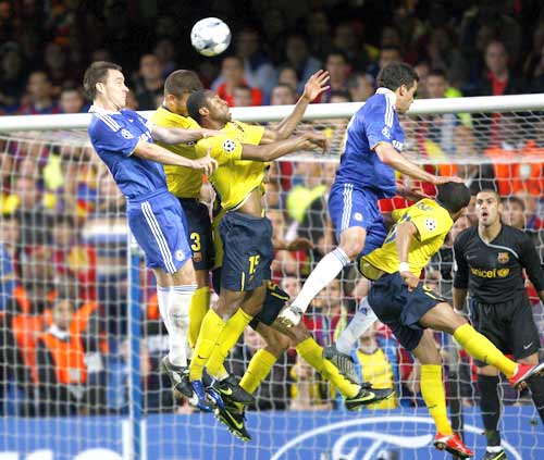 John Terry (left) and Michael Ballack (2nd from right) of Chelsea; Daniel Alves (right), Sergio Alves (center) and Gerard Pique of Barcelona jump for the ball