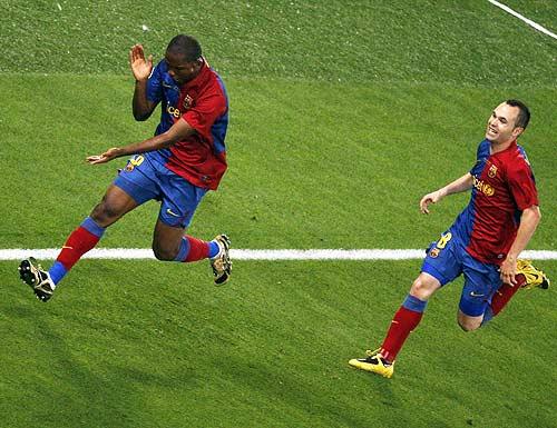 Samuel Eto'o (left) celebrates with Andres Iniesta after scoring the first goal