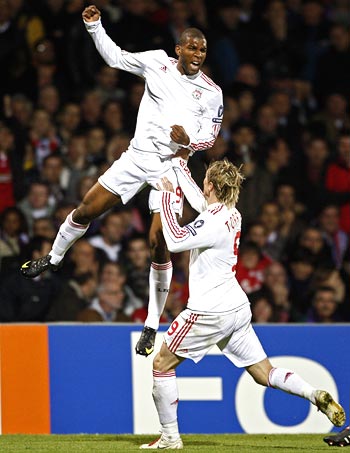 Liverpool's Ryan Babel (left) celebrates with team-mate Fernando Torres after scoring against Olympique Lyon
