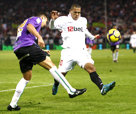 Sevilla's Luis Fabiano (right) and Malaga's Gonzalez vie for possession
