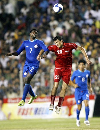 India striker NP Pradeep (left) fights for the ball against Syria's Feras Ismail