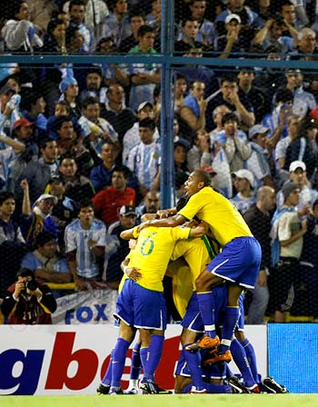 Brazil players celebrate after Luisao scored the opening goal