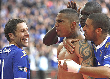 Portsmouth's Kevin Prince Boateng is congratulated by team-mates after scoring the vital penalty