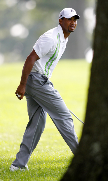 Tiger Woods looks on during first round play at the WCG Bridgestone Invitational golf tournament
