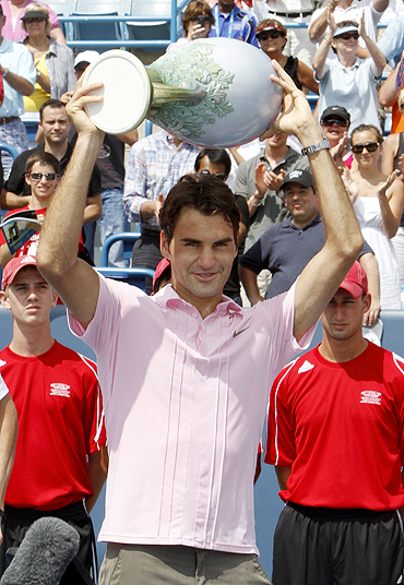 Roger Federer holds up the championship trophy after defeating Mardy Fish at the Cincinnati Masters final on Sunday