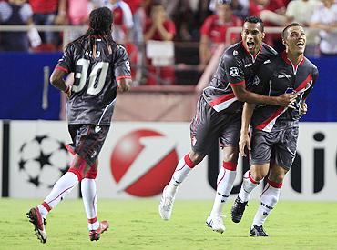 Braga's Lima (right) celebrates with teammate Elton after scoring Braga's third goal against Sevilla on Tuesday