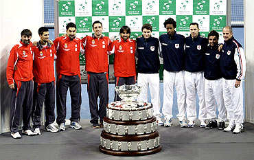 Members of Serbian and French tennis teams pose with the Davis Cup trophy after the official draw at Belgrade Arena
