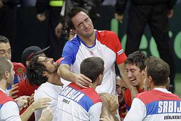 Serbia's Viktor Troicki celebrates after beating France's Michael Llodra during their Davis Cup final match in Belgrade