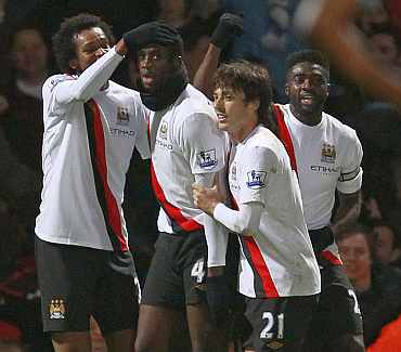 Man City's Ya Ya Toure celebrates with team-mates after scoring against West Ham