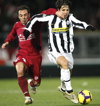 Livorno's Filippini (left) challenges Juventus's Diego as they vie for possession during their Serie A match on Saturday