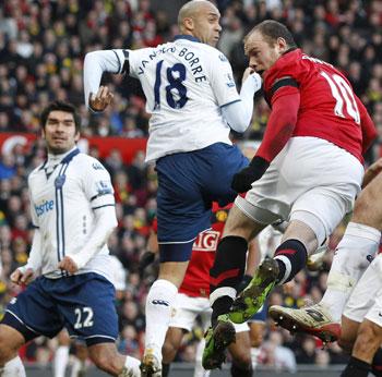 Wayne Rooney heads the ball past Portsmouth's Vanden Borre during their EPL tie on Saturday