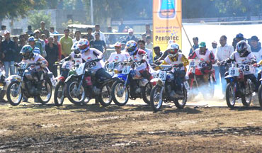 Motorcyclists shoot out from the gates in the Local Class race