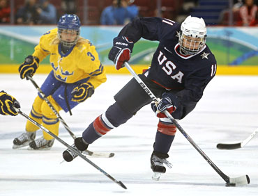 Lisa Chesson of the US maneuvers the puck during their women's ice hockey play-offs semifinals against Sweden