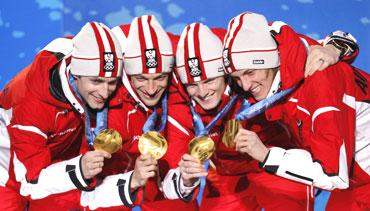 The Austrian gold medal-winning ski jump team show off their medals