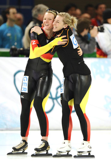 Germany's Stephanie Beckert (left) is embraced by team-mate Anna Friesinger-Postma after winning the women's speed skating team pursuit event