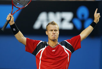 Lleyton Hewitt waves to the crowd after his opponent Marcos Baghdatis retired from the match.