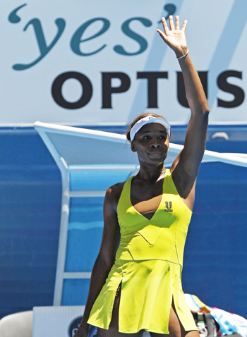 Venus Williams waves after defeating Italy's Francesca Schiavone