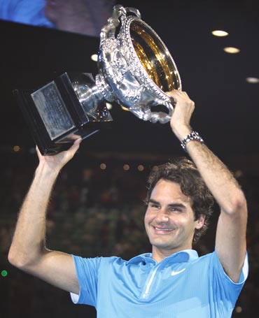 Roger Federer with the winners trophy