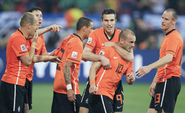 Netherlands' Wesley Sneijder celebrates his goal with team mates including Robin van Persie and Andre Ooijer during their quarter-final against Brazil in Port Elizabeth