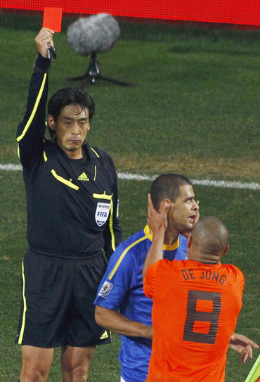 Referee Yuichi Nishimura of Japan shows the red card to Brazil's Felipe Melo (C) during their 2010 World Cup quarter-final soccer match in Port Elizabeth