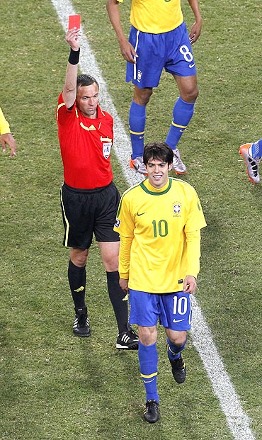 Kaka walks off the pitch after being shown the red card by French referee Stephane Lannoy