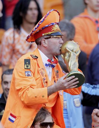 A Dutch fan kisses a replica of the World Cup trophy