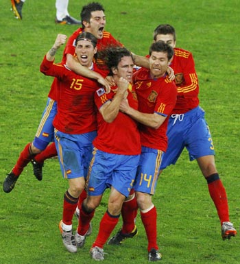 Spanish players celebrate with Puyol (centre)