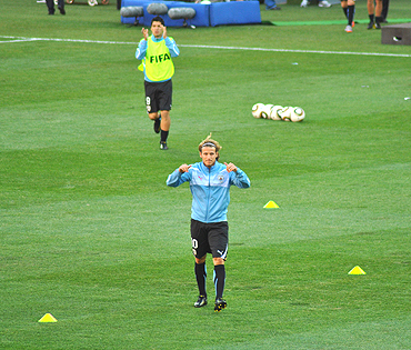 Diego Forlan acknowledges the crowd as he warms up before the South Korea match