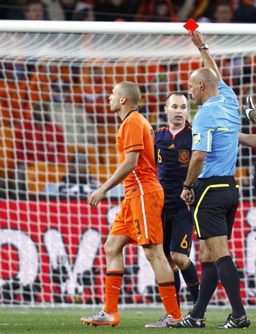 John Heitinga (left) is shown the red card by referee Howard Webb