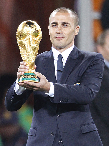 Fabio Cannavaro of Italy, captain of the 2006 World Cup winning team, holds up the trophy before the World Cup final on Sunday