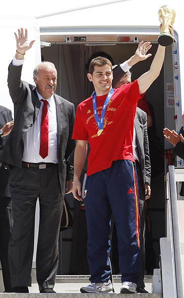 Spain's captain Iker Casillas lifts the World Cup trophy after arriving at Madrid's Barajas airport