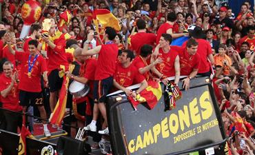 Spain's players celebrate their World Cup victory on an open-top bus during a parade in downtown Madrid