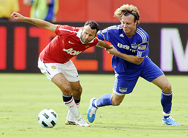 Manchester United's Ryan Giggs (left) is challenged by Kansas City Wizards's Michael Harrington during their friendly tie at Arrowhead Stadium in Kansas City, Missouri on Sunday