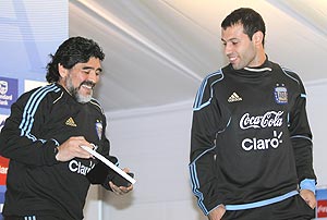Argentina's national soccer team coach Diego Maradona (L) shows to captain Javier Mascherano a portrait of himself with his grandson Benjamin at the squad camp in Pretoria