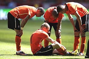 Arjen Robben of the Netherlands sits on the pitch surrounded by teammates Gregory van der Wiel (left), Nigel de Jong (centre), and Ibrahim Afellay after injuring himself during their international friendly soccer match against Hungary